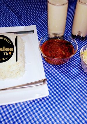 A picture of White and rice with coleslow and tigernut drink.