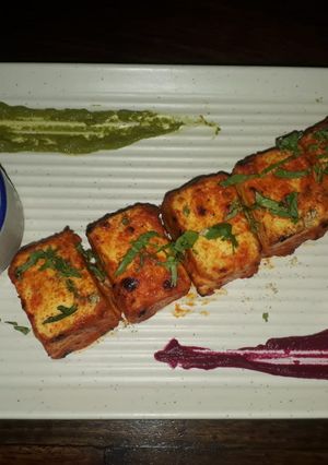 A picture of Lasanda paneer tikka with kimchi salad.