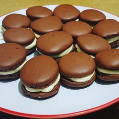A picture of Chocolate Macarons with a White Chocolate Ganache filling.