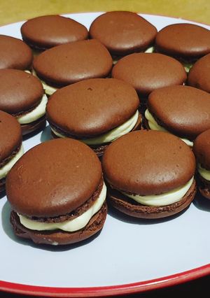 A picture of Chocolate Macarons with a White Chocolate Ganache filling.