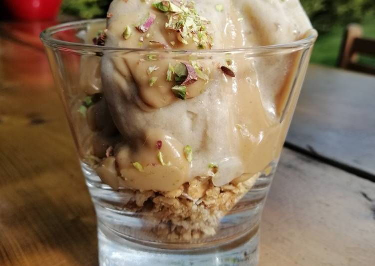 Banana ice cream with granola and peanut butter sauce