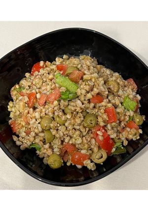 A picture of Farro Salad with Pesto, Iceberg Lettuce, Basil, Green Olives, Tomatoes, and Tuna.