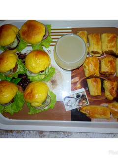 A picture of Pineapple juice with sausage Roll.