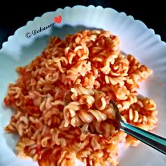 A picture of Pasta with carrot tomato sauce.