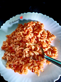 A picture of Pasta with carrot tomato sauce.