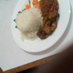 A picture of Chicken tikka India served with plain rice.