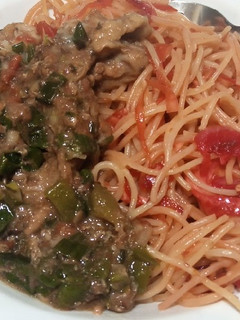 A picture of Veg salad and spaghetti dinner.