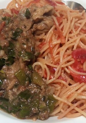 A picture of Veg salad and spaghetti dinner.