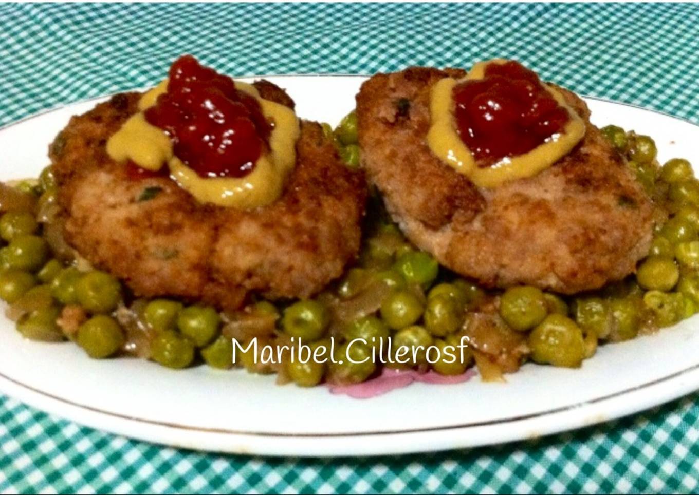 Filetes de carne picada con guarnición de guisantes