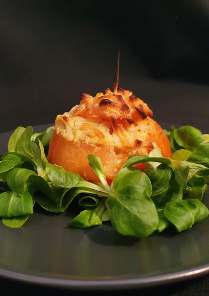 Una foto de *Tomates gratinados rellenos de hummus y huevo*