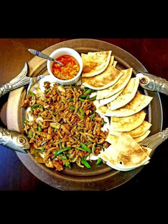 A picture of Steak and eggs with pita.