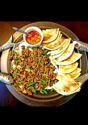 A picture of Steak and eggs with pita.