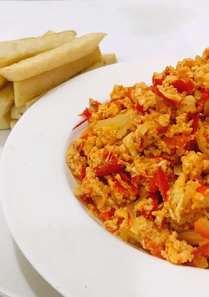 A picture of Scrambled eggs and fried yam.