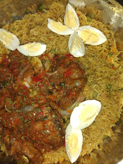 A picture of Fried rice with peppered chicken.