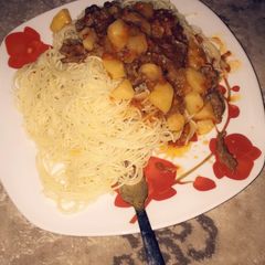A picture of Spaghetti and shredded beef with potato soup.