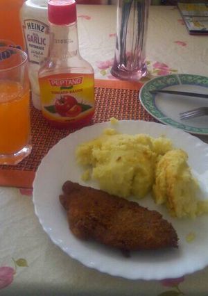 A picture of Coated fish fillet with mashed potatoes.