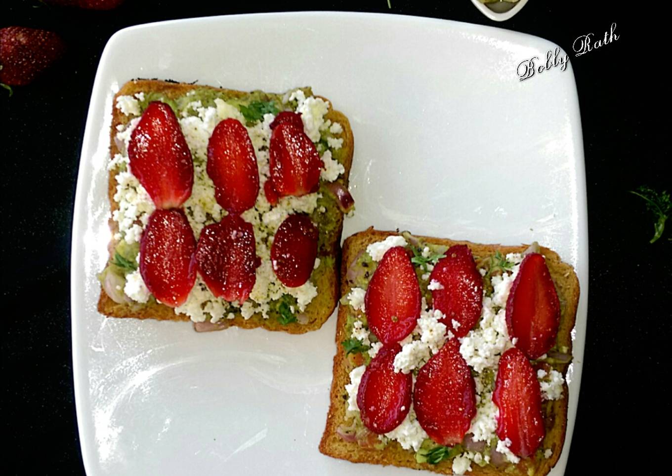 Cheesy guacamole strawberry open sandwich