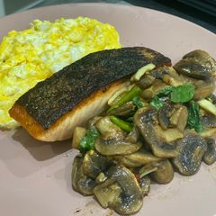 A picture of Grilled salmon with stir-fried mushroom with Thai basil.