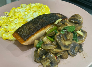 A picture of Grilled salmon with stir-fried mushroom with Thai basil.