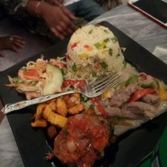A picture of Fried rice,fried plantain,shredded meat.