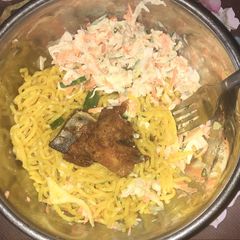 A picture of Indomie and chicken with salad.