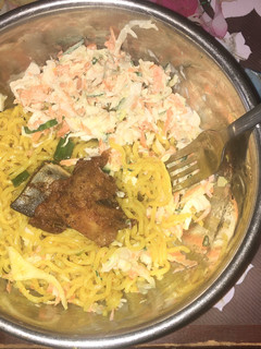 A picture of Indomie and chicken with salad.