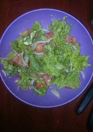 Una foto de Ensalada de tomate, lechuga, cebolla y pepinitos