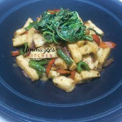 A picture of Stir fry yam top with spinach.