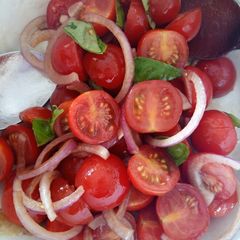 A picture of Tomato, red onion, basil and balsamic salad.