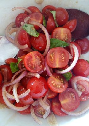 A picture of Tomato, red onion, basil and balsamic salad.