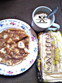 A picture of Tea and bread with fried egg.