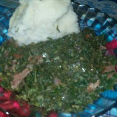 Green mixed up with red meat and ugali A picture of Green mixed up with red meat and ugali.