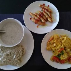 A picture of Bread,Fried egg with sausage with tea.