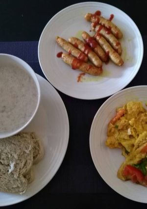 A picture of Bread,Fried egg with sausage with tea.