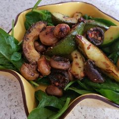 A picture of My Buttered Salt n pepper Mushroomson,Advocado on bed of Spinach.