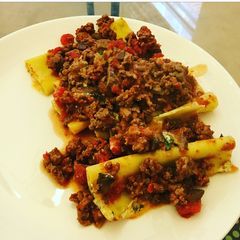 A picture of Cheese and Spinach stuffed Cannelloni with a meat ragù.
