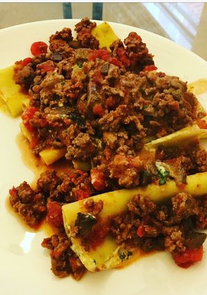 A picture of Cheese and Spinach stuffed Cannelloni with a meat ragù.