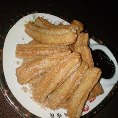 A picture of Cinnamon churros and cinnamon chocolate sauce.