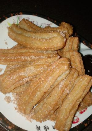 A picture of Cinnamon churros and cinnamon chocolate sauce.