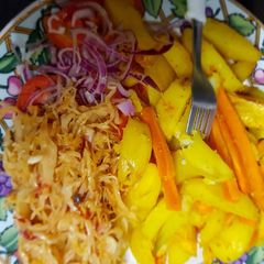 A picture of Roast potatoes, carrots served with cabbage and kachumbari.