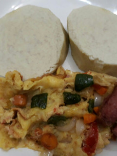 A picture of Boiled yam with fried eggs and sausages.