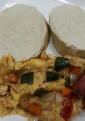 A picture of Boiled yam with fried eggs and sausages.