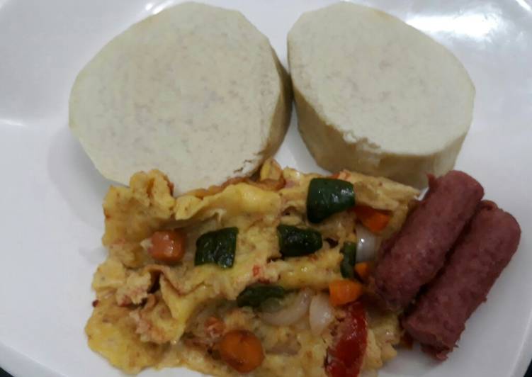 Boiled yam with fried eggs and sausages