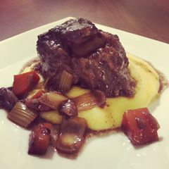 A picture of Braised oxtail in a red wine reduction .