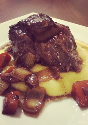 A picture of Braised oxtail in a red wine reduction .