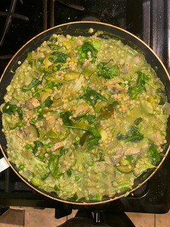 A picture of Leek and onion cous cous w pesto sauce.