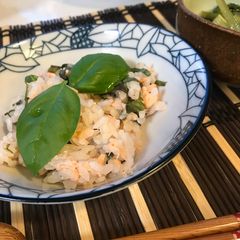 A picture of Salmon Sushi with Fresh Basil.