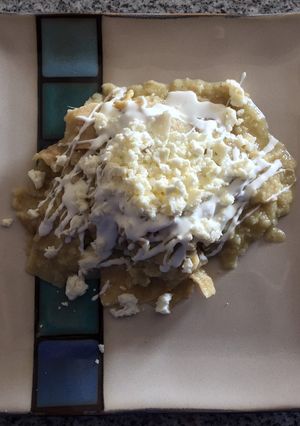 Una foto de Chilaquiles verdes con crema y queso