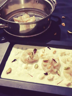 A picture of Apple Kalakand Momo drizzled with Rabdi.
