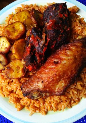 A picture of Jollof rice,fried olantain and fried turkey.